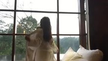 Girl gets naked in front of window