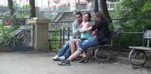 Threesome on a bench with a cute woman