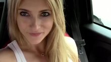 Sexy blonde in a car with her pink dildo